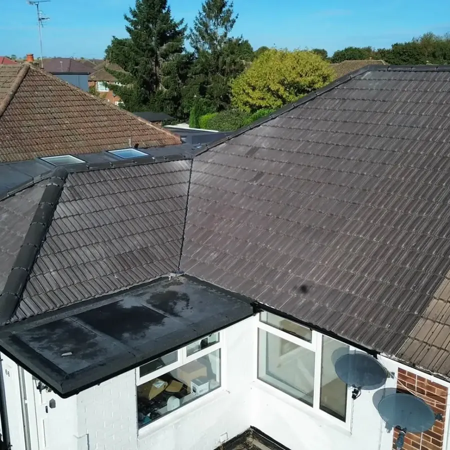 Aerial view of a refurbished tiled roof on a bungalow with a new flat roof extension