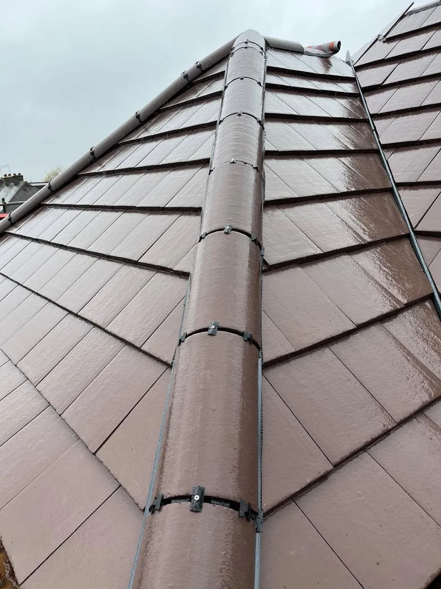 Close-up of new clay tiles, dormer and lead work